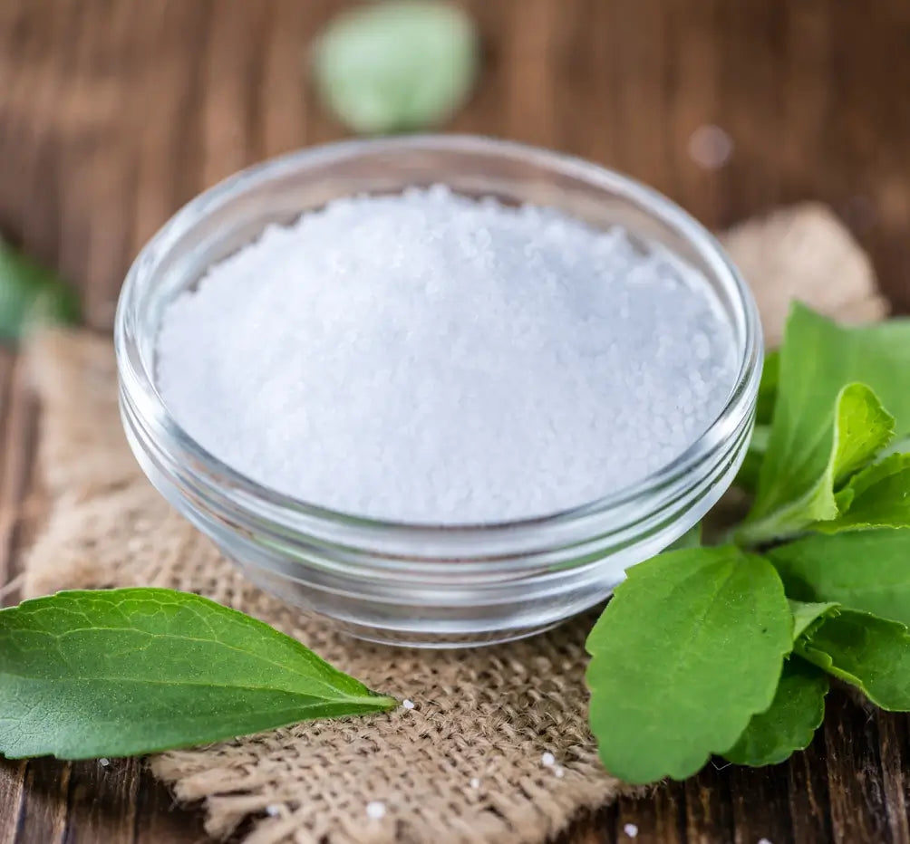 Powdered stevia drops in a transparent cup